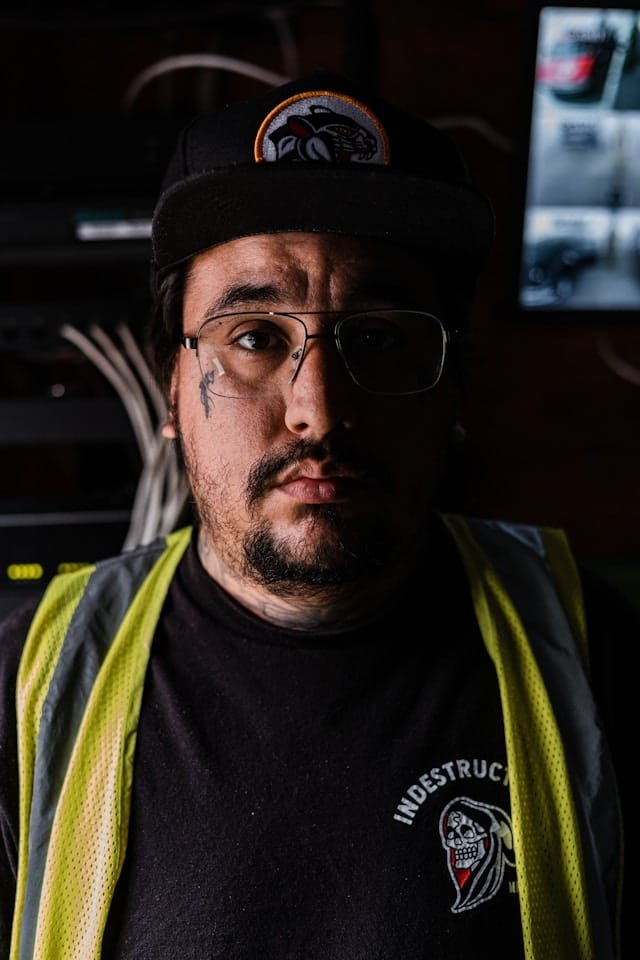 A man wearing a hat and glasses